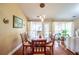 Elegant dining room featuring hardwood floors, natural light, and seating for six at 1055 Kibbe Cir, Lawrenceville, GA 30044