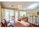 Hardwood dining room with updated lighting that flows into the home's living area at 1055 Kibbe Cir, Lawrenceville, GA 30044