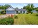 Charming single-story home with a well-manicured lawn, gray garage door, and lovely landscaping at 1055 Kibbe Cir, Lawrenceville, GA 30044