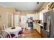 Eat-in kitchen features stainless appliances, cream-colored cabinetry, and a breakfast table at 1055 Kibbe Cir, Lawrenceville, GA 30044
