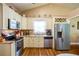 Well-lit kitchen features stainless appliances, granite counters and cream-colored cabinetry at 1055 Kibbe Cir, Lawrenceville, GA 30044