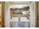 Neat laundry room with washer, dryer, and storage shelves, ideal for efficient home organization at 1055 Kibbe Cir, Lawrenceville, GA 30044