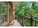 Balcony with brick exterior, metal railing, and beautiful views of the lush trees and landscape at 1717 N Decatur Ne Rd # 117, Atlanta, GA 30307