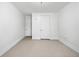 Clean bedroom with neutral carpet, white walls, white doors, white trim, and electric outlets at 1717 N Decatur Ne Rd # 117, Atlanta, GA 30307
