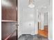 Hallway featuring a dark wood door, tile floor, and trim with white walls, creating a classic design at 1717 N Decatur Ne Rd # 117, Atlanta, GA 30307