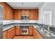 Well-lit kitchen featuring stainless steel appliances, wood cabinets, granite countertops, and a modern design at 1717 N Decatur Ne Rd # 117, Atlanta, GA 30307