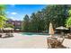 Outdoor swimming pool area with lounge chairs and seating amidst lush landscaping at 1717 N Decatur Ne Rd # 117, Atlanta, GA 30307