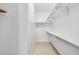 Walk-in closet with built-in shelving for ample storage, carpeted floors and white walls at 1717 N Decatur Ne Rd # 117, Atlanta, GA 30307