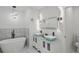 Bathroom featuring double vanity, accent lighting, and a soaking tub at 3634 Oakleaf Pass, Fairburn, GA 30213
