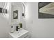 Sleek powder room boasts modern lighting and fixtures at 3634 Oakleaf Pass, Fairburn, GA 30213