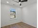 Bright bedroom with a ceiling fan, hardwood floor, and natural light at 3634 Oakleaf Pass, Fairburn, GA 30213