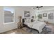 Bedroom featuring three windows, ample sunlight, and hardwood floors at 3634 Oakleaf Pass, Fairburn, GA 30213