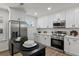 Modern kitchen with white cabinets, stainless steel appliances, and ample counter space for cooking and entertaining at 3634 Oakleaf Pass, Fairburn, GA 30213