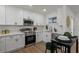 Modern kitchen with white cabinets, stainless steel appliances, and an island for casual dining and meal prep at 3634 Oakleaf Pass, Fairburn, GA 30213