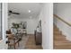 Light and airy living room with modern decor, hardwood floors, and a staircase leading to the upper level at 3634 Oakleaf Pass, Fairburn, GA 30213
