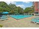 Resort style community pool with lounge chairs and umbrellas for relaxing by the water at 377 Ralph Mcgill Ne Blvd # C, Atlanta, GA 30312