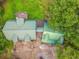 Aerial view of home with green metal roof, surrounded by lush greenery at 519 E Valley Ne Rd, Rydal, GA 30171