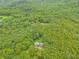 Drone shot of home nestled in a forest, with lush trees and foliage surrounding it at 519 E Valley Ne Rd, Rydal, GA 30171