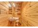 Cozy bathroom featuring wood paneled walls, toilet, sink, mirror and shelves at 519 E Valley Ne Rd, Rydal, GA 30171