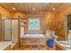 Bathroom featuring a shower and tub, wood paneling, and natural light at 519 E Valley Ne Rd, Rydal, GA 30171