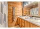 Bathroom featuring wood paneling, double sinks, and natural light at 519 E Valley Ne Rd, Rydal, GA 30171