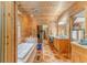 Bright bathroom with a large jacuzzi style tub, wood paneling, and ample counter space at 519 E Valley Ne Rd, Rydal, GA 30171