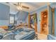 Blue painted bedroom with ample closet space and a door to an attic area at 519 E Valley Ne Rd, Rydal, GA 30171