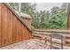 Outdoor deck with wood railing overlooking lush greenery and a wooded area at 519 E Valley Ne Rd, Rydal, GA 30171