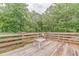 Open wood deck surrounded by railings, perfect for enjoying the serene wooded views at 519 E Valley Ne Rd, Rydal, GA 30171