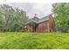 Exterior view of rustic log cabin-style home with elevated deck and lush surrounding greenery at 519 E Valley Ne Rd, Rydal, GA 30171
