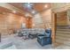 Spacious living room featuring wood walls, plush carpeting and staircase at 519 E Valley Ne Rd, Rydal, GA 30171