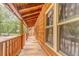 Inviting covered porch with wood plank flooring and railing offering a scenic view at 519 E Valley Ne Rd, Rydal, GA 30171