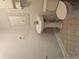 A pedestal sink and matching toilet with tiled floors give this bathroom a charming, clean look at 8291 Highway 5, Whitesburg, GA 30185