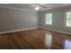 Spacious bedroom with hardwood floors, neutral paint, and a ceiling fan for a modern, clean aesthetic at 8291 Highway 5, Whitesburg, GA 30185