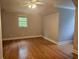 Bright bedroom with hardwood floors, ceiling fan and a window allowing natural light to flow in at 8291 Highway 5, Whitesburg, GA 30185