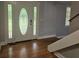 Well-lit foyer featuring an elegant front door, hardwood flooring, and staircase at 8291 Highway 5, Whitesburg, GA 30185