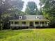 Charming single-story home with a welcoming front porch and well-manicured lawn at 8291 Highway 5, Whitesburg, GA 30185
