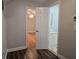 Open doorways reveal a bedroom and bathroom with a contrast in flooring and fixtures at 8291 Highway 5, Whitesburg, GA 30185