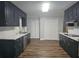 Modern kitchen featuring sleek black cabinets, stainless steel appliances, and ample counter space at 8291 Highway 5, Whitesburg, GA 30185
