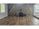 Spacious living room with wood-look floors, stone accents, and ample natural light at 8291 Highway 5, Whitesburg, GA 30185