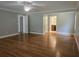 A large living room with hardwood floors and multiple entryways exudes comfort and spaciousness at 8291 Highway 5, Whitesburg, GA 30185