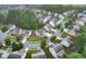 Aerial view showcasing a neighborhood with well-maintained homes, tree-lined streets, and lush greenery at 893 Whitfield Oak Rd, Auburn, GA 30011