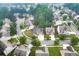 Aerial shot of a residential neighborhood featuring a house with solar panels and mature trees at 893 Whitfield Oak Rd, Auburn, GA 30011