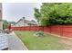 View of a well-maintained backyard with a wooden fence and manicured lawn, perfect for outdoor enjoyment at 893 Whitfield Oak Rd, Auburn, GA 30011