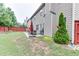 Spacious backyard featuring a patio with outdoor furniture, a grill, and landscaping at 893 Whitfield Oak Rd, Auburn, GA 30011