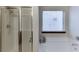 Bathroom featuring a glass enclosed shower, a bathtub, and a window at 893 Whitfield Oak Rd, Auburn, GA 30011