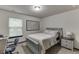 Well-lit bedroom with a desk, chair, and neutral decor for a comfortable living space at 893 Whitfield Oak Rd, Auburn, GA 30011
