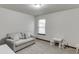 Neutral bedroom with a comfortable sofa and a small table set at 893 Whitfield Oak Rd, Auburn, GA 30011
