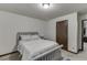Well-lit bedroom with a bed, nightstand, and neutral decor for a comfortable space at 893 Whitfield Oak Rd, Auburn, GA 30011