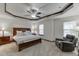 Spacious primary bedroom with a modern ceiling fan and comfortable seating area at 893 Whitfield Oak Rd, Auburn, GA 30011